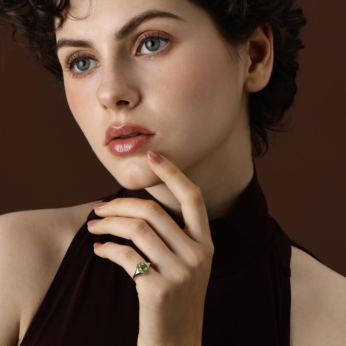 Model Wearing the Evie Pear Cut Lime Green Tourmaline Ring in yellow gold
