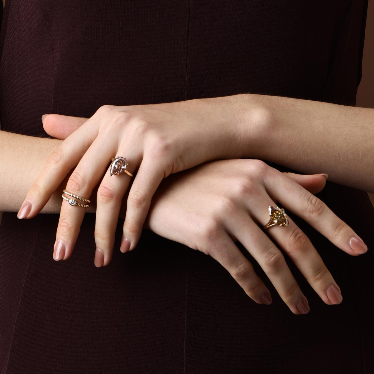 The Jasper brown pink pear cut lab grown diamond engagement ring worn on hand with a brown marquise cut diamond ring