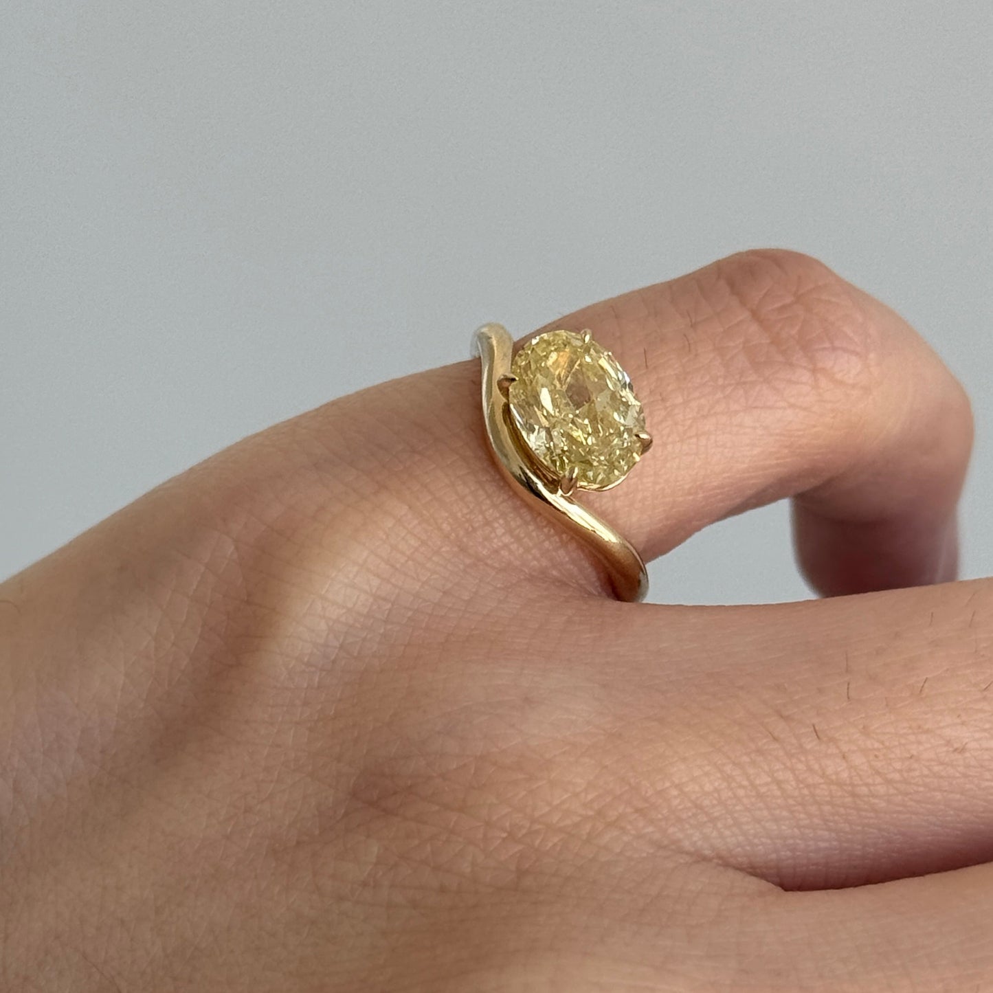 Yellow oval cut lab grown diamond ring worn as a pinky ring