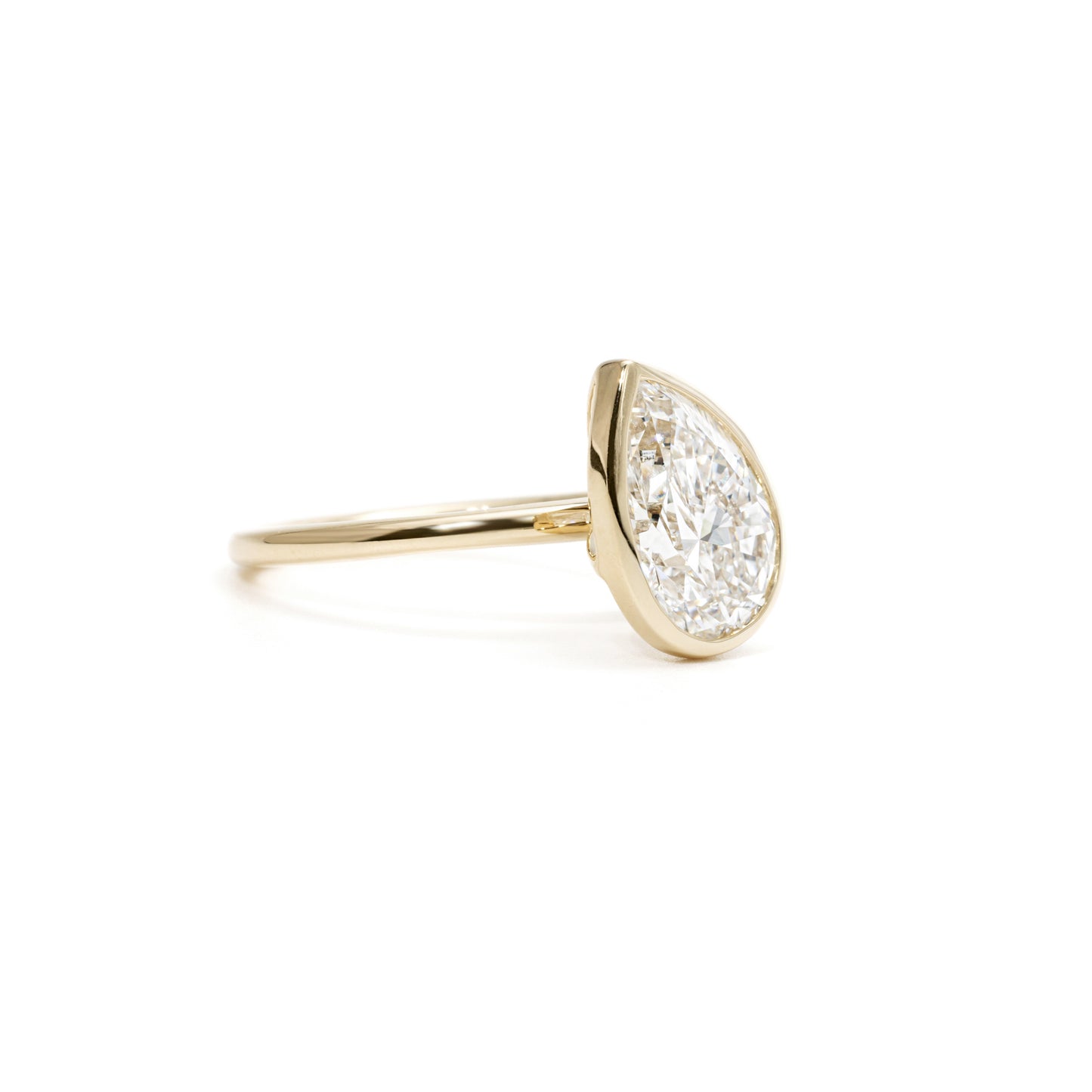 Angled-view Sofia Tilted Pear Cut Diamond Bezel Ring in 14K Gold