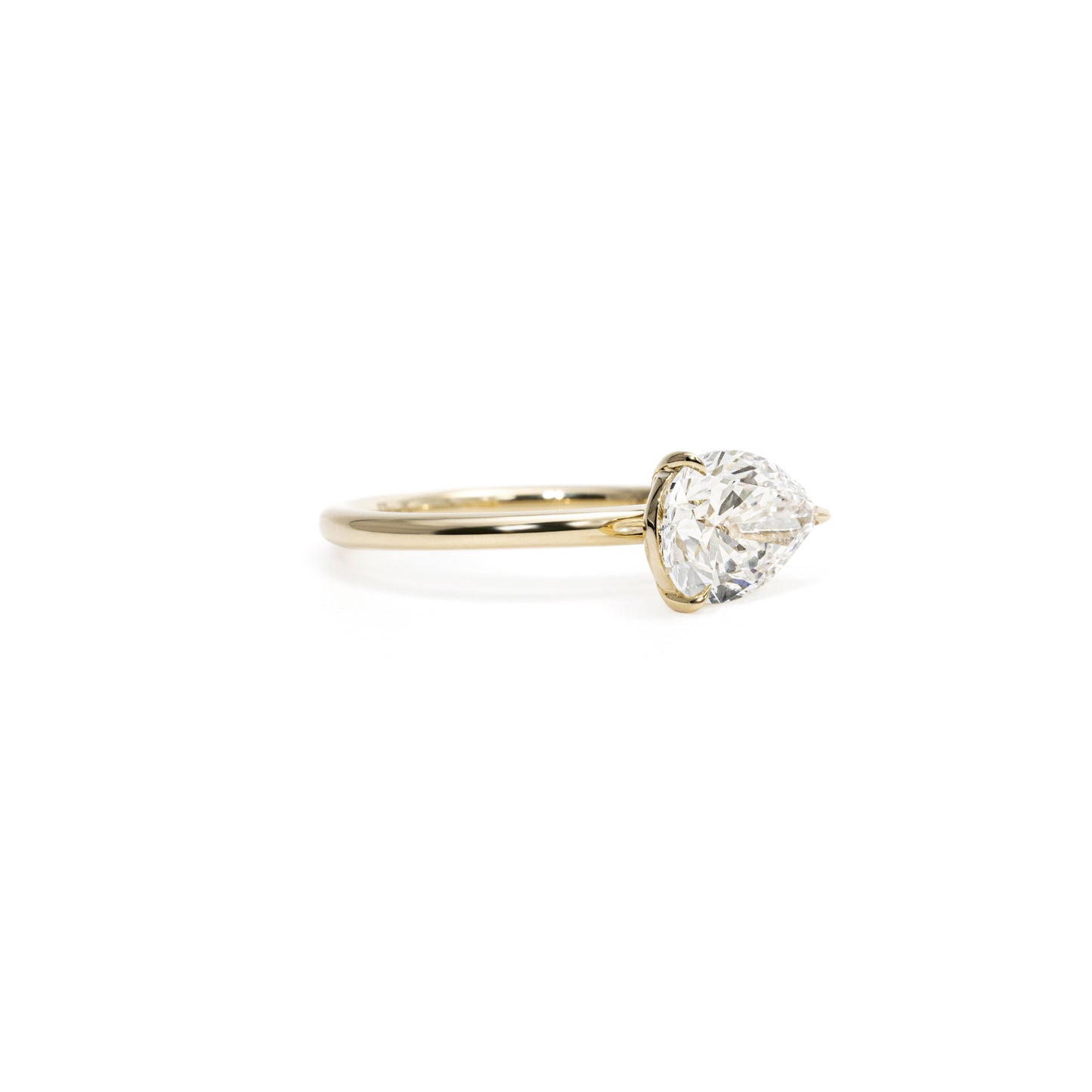 Angled View Quinn East-West Pear Cut Lab Diamond Engagement Ring with secure prong setting and tapered band