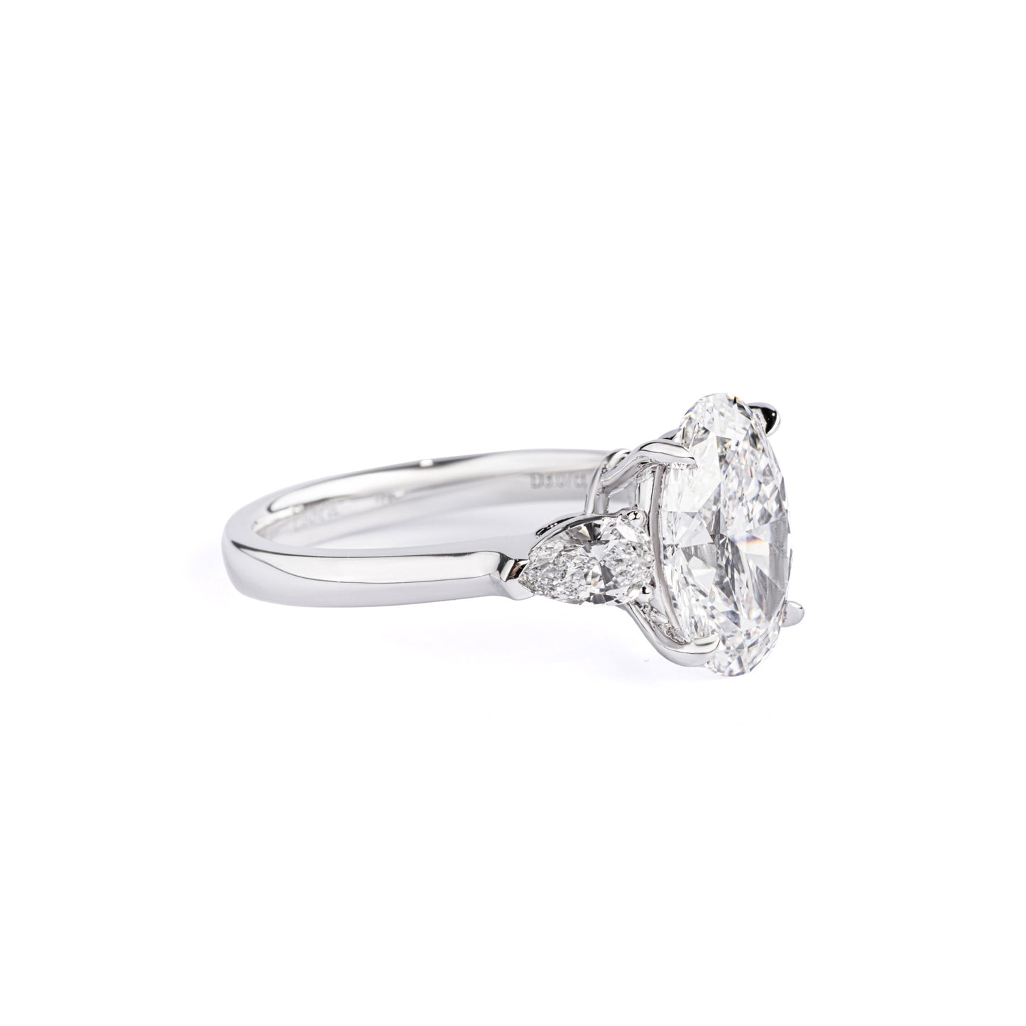 Angled View Three-Stone Oval Diamond Engagement Ring flanked by two pear-shaped diamonds