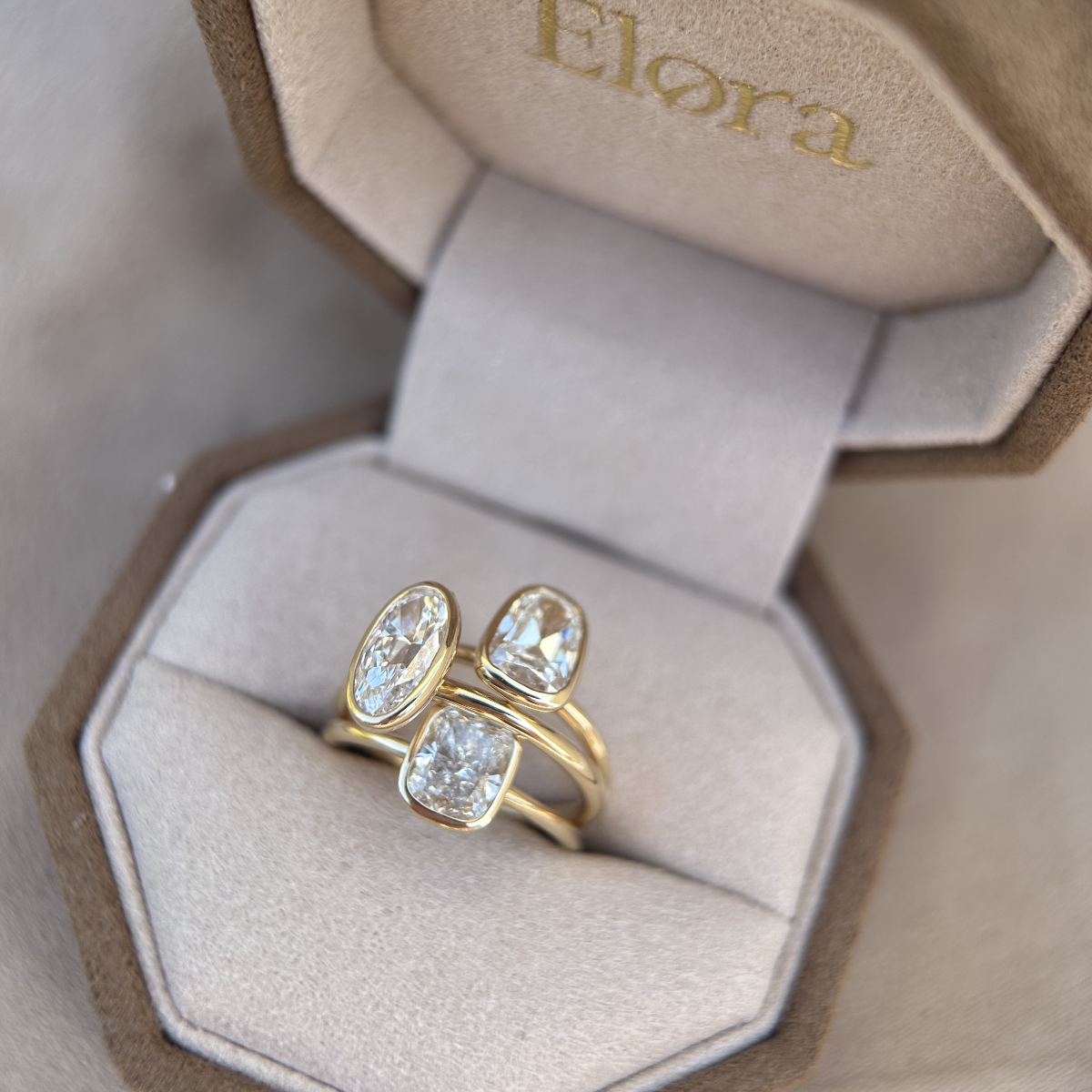 Bezel set diamond rings shown inside Elora jewelry box, emphasizing its timeless design