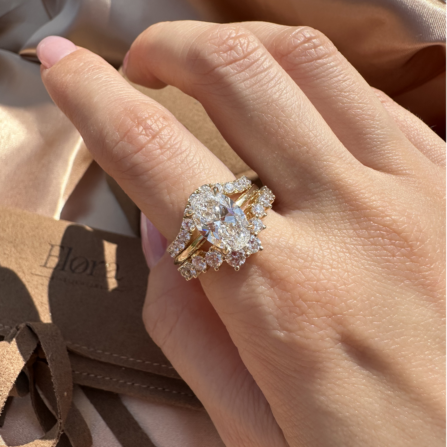 Bold stacked ring look with Oval Cut Diamond ring paired with pavé and curved wedding bands