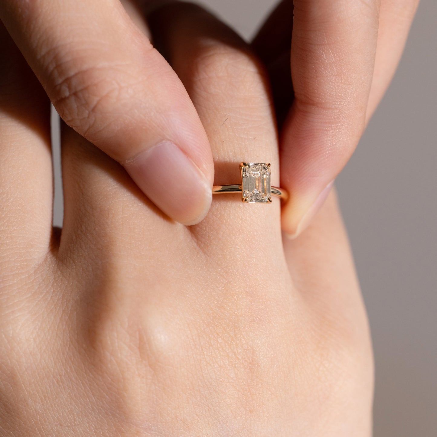 Close-up view 1ct Emerald Cut Lab Diamond Solitaire Ring on Model's Finger