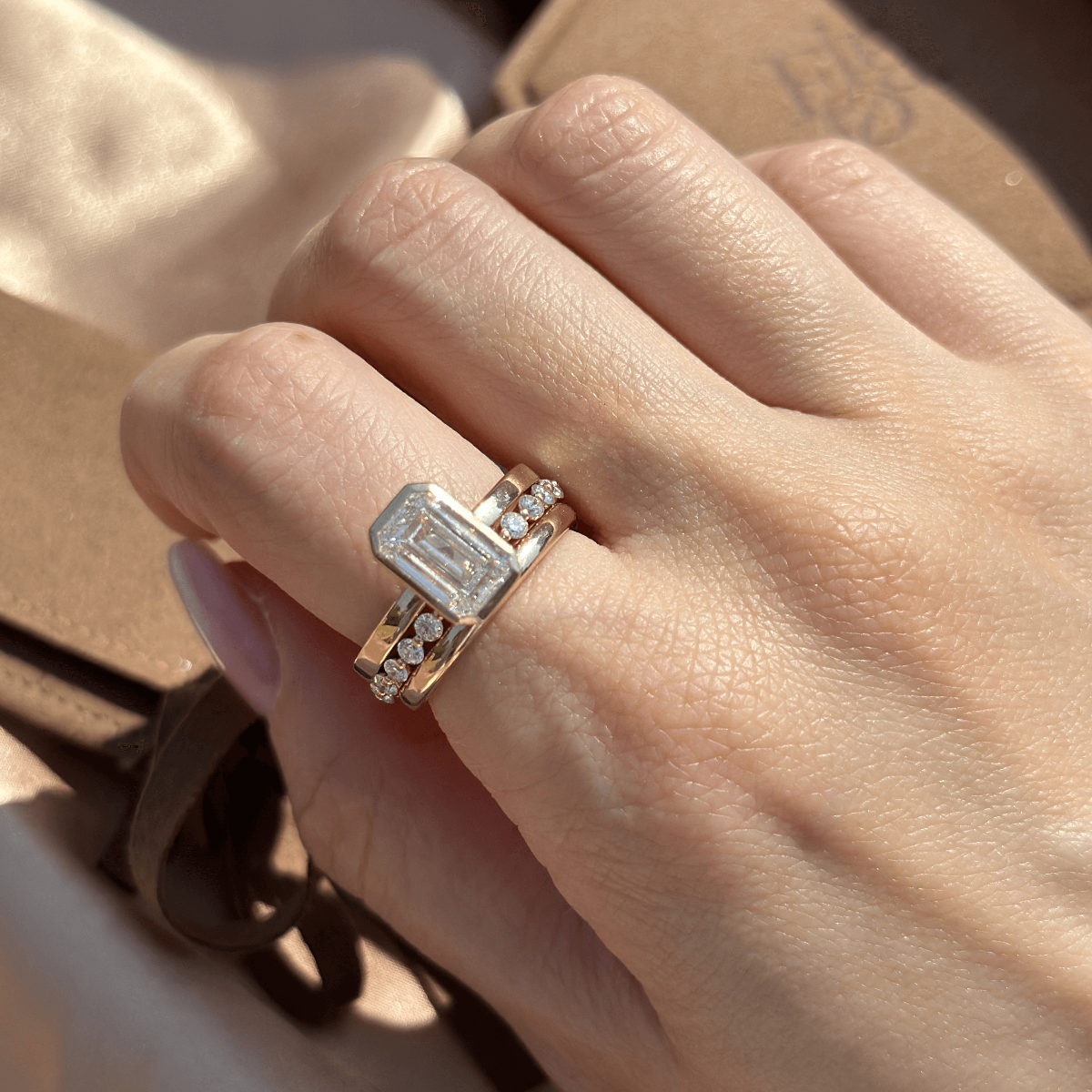 Emerald cut Diamond Ring styled in a modern ring stack with Eternity and Gold wedding band