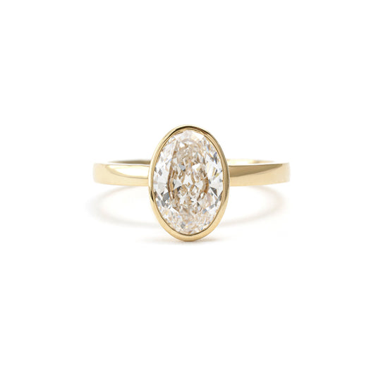 Front view of Eleanor Oval Cut Lab Grown Diamond Bezel Ring in 14K yellow gold