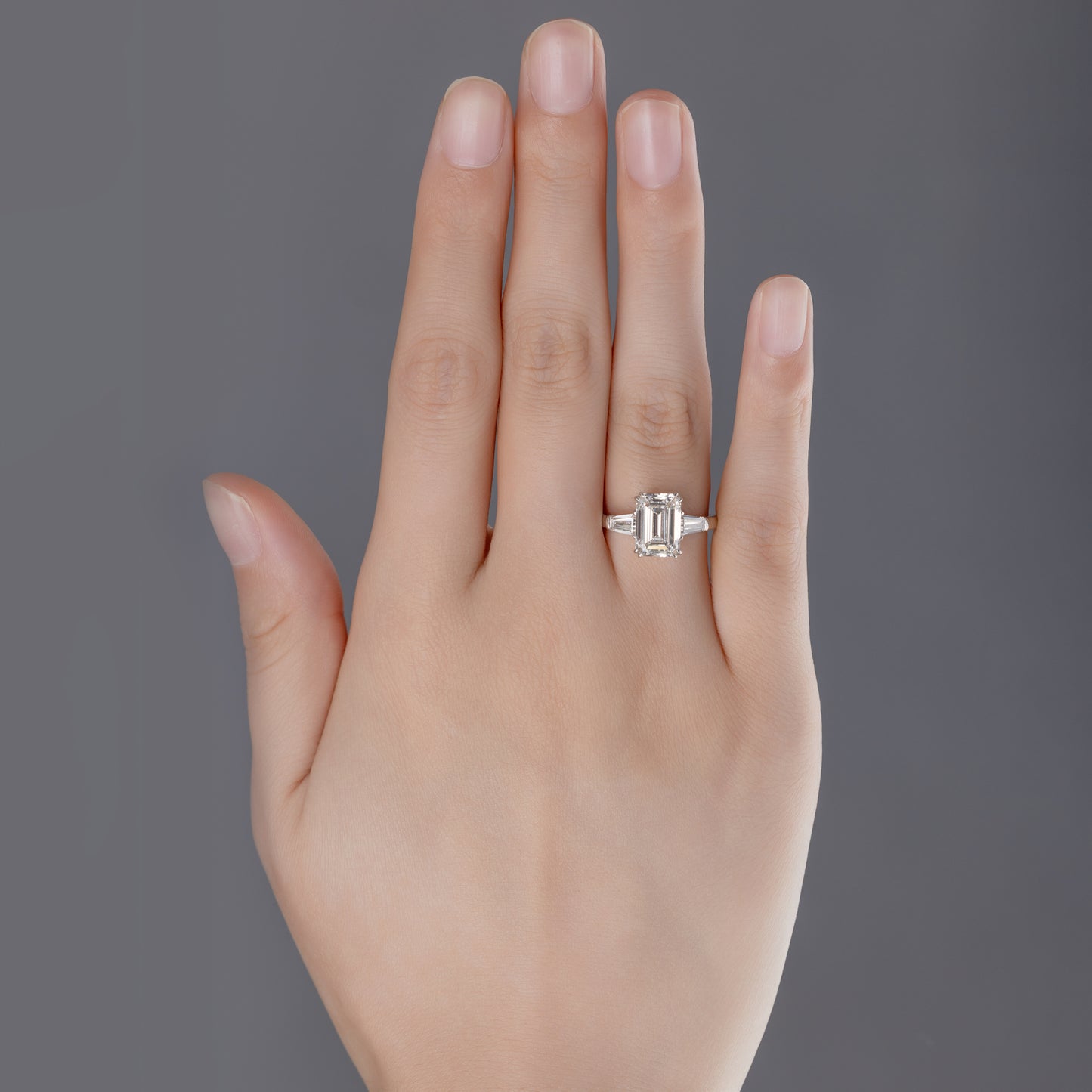Gemma Emerald Cut Lab Grown Diamond Three Stone Ring in platinum on ring finger