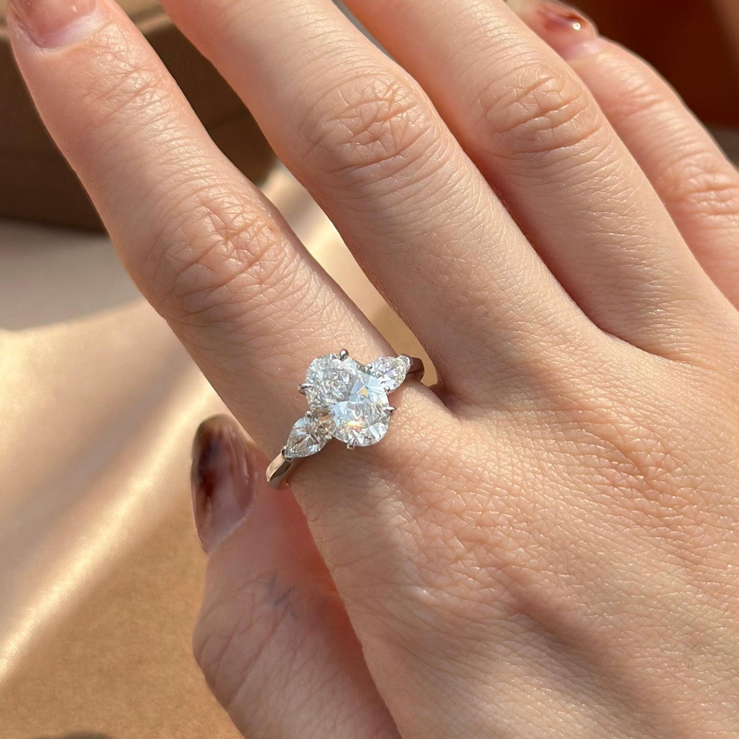 Hand-closeup Dakota Three Stone Oval Cut Lab Grown Diamond Engagement Ring