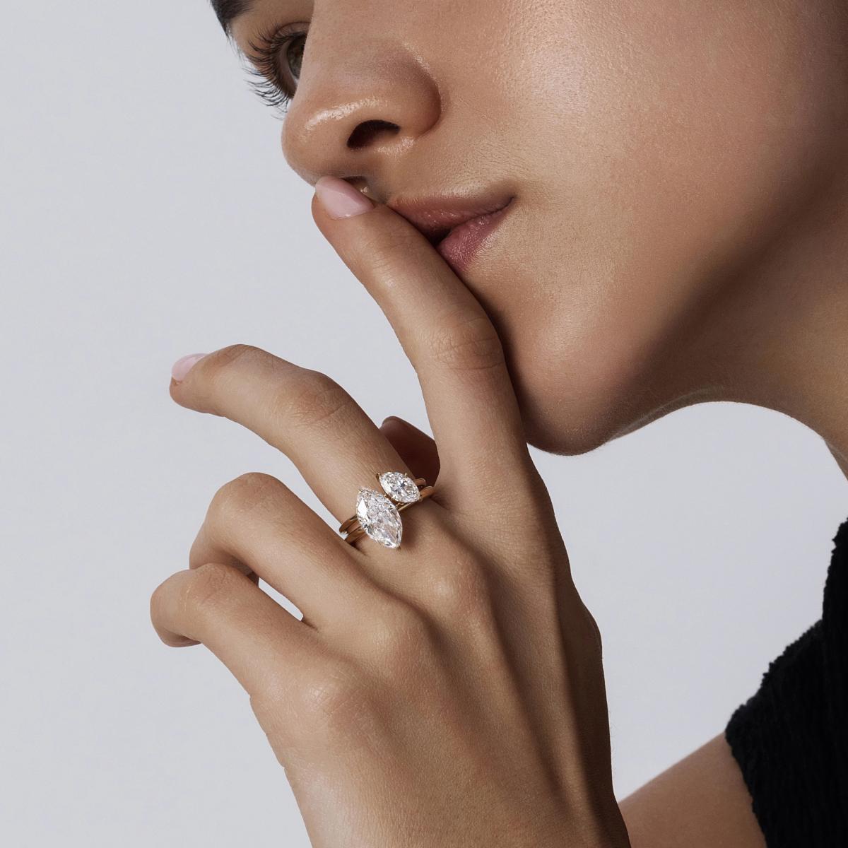 Hand-closeup of Two Marquise cut diamond solitaire rings