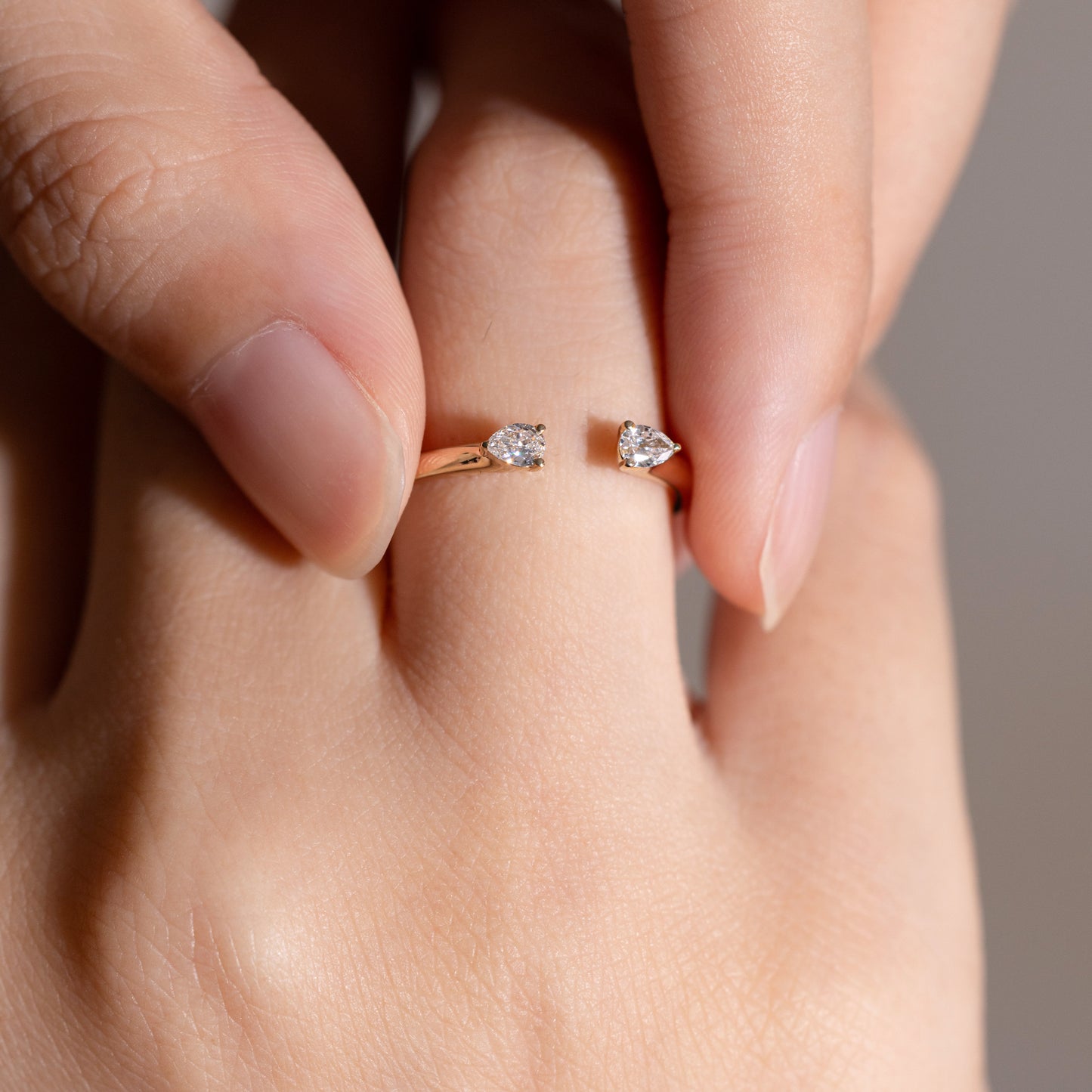 Minimalist gold open ring with ethical diamonds, photographed on white