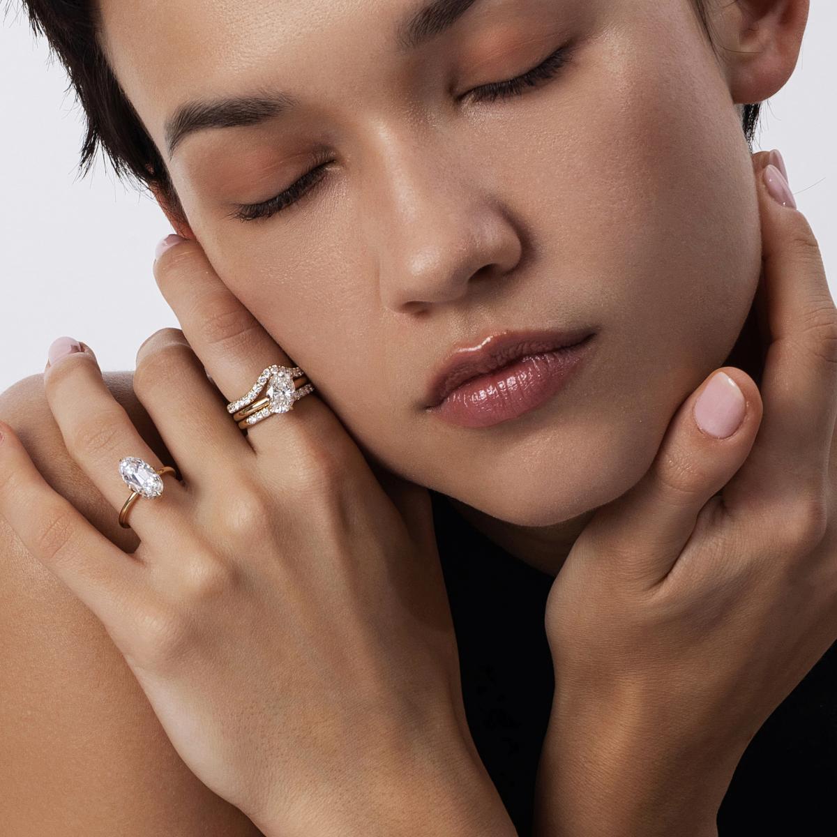 Model hand showcasing Belle Moval cut diamond ring in four-prong setting