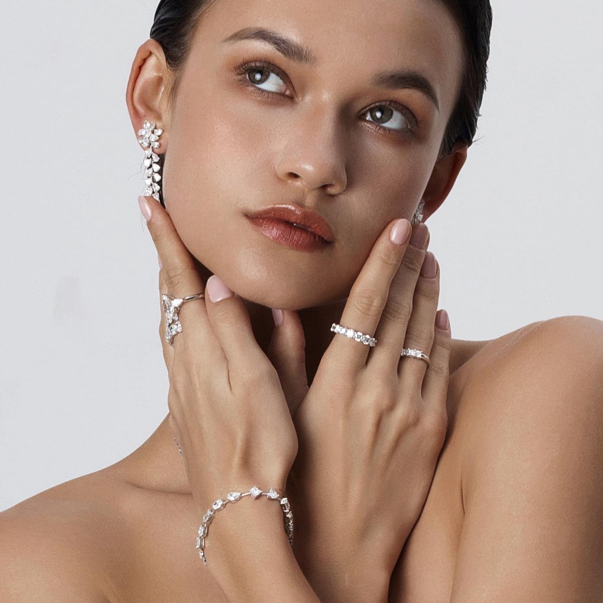 Model styling Several Diamond Eternity Bands in Platinum for a bold layered look