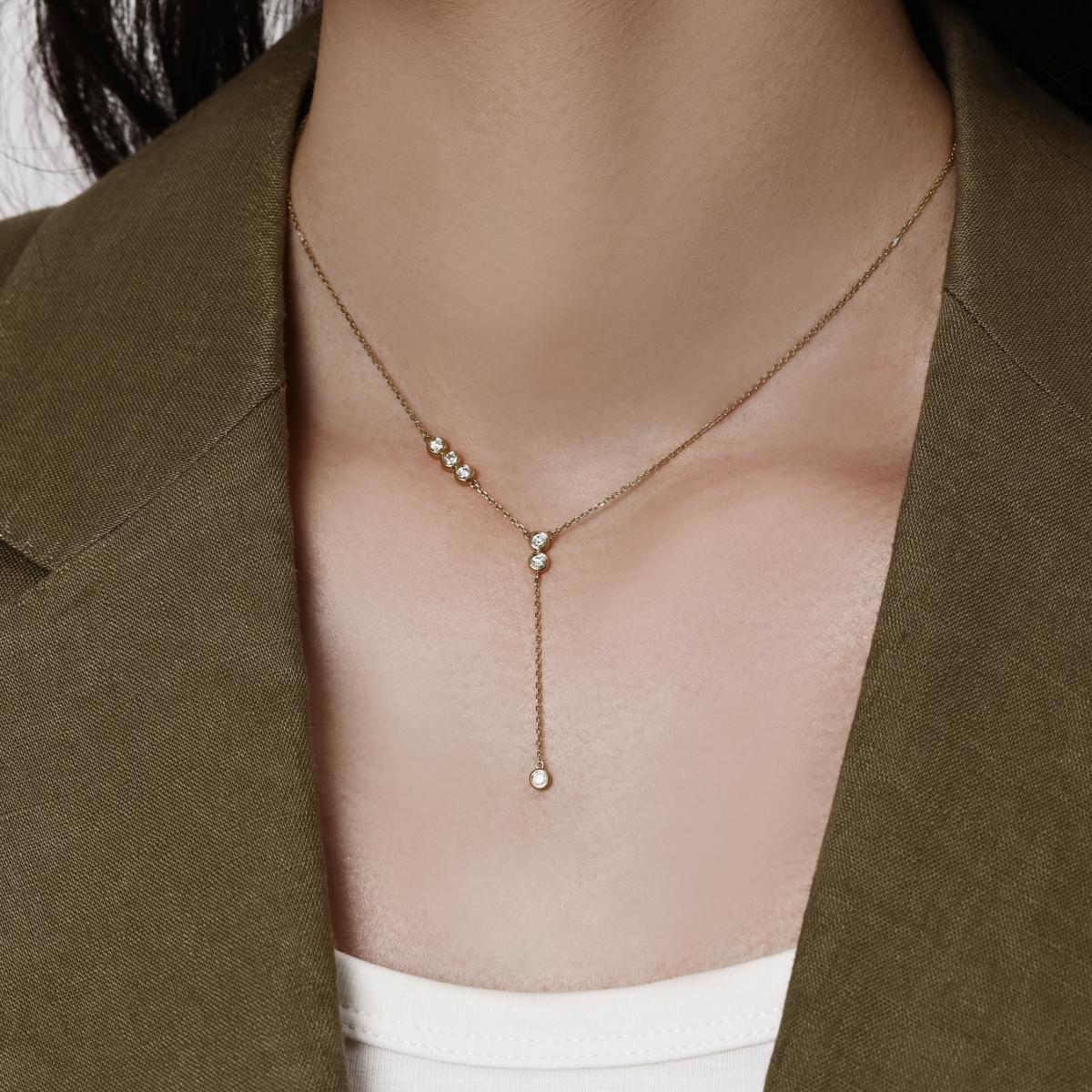 Model wearing Cascade bezel-set round Diamond Lariat Necklace in a modern Y-shaped silhouette