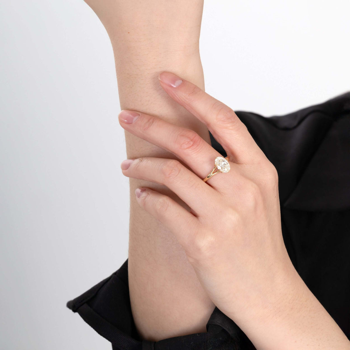 Model wearing Edith Oval lab-grown diamond engagement solitaire ring on finger