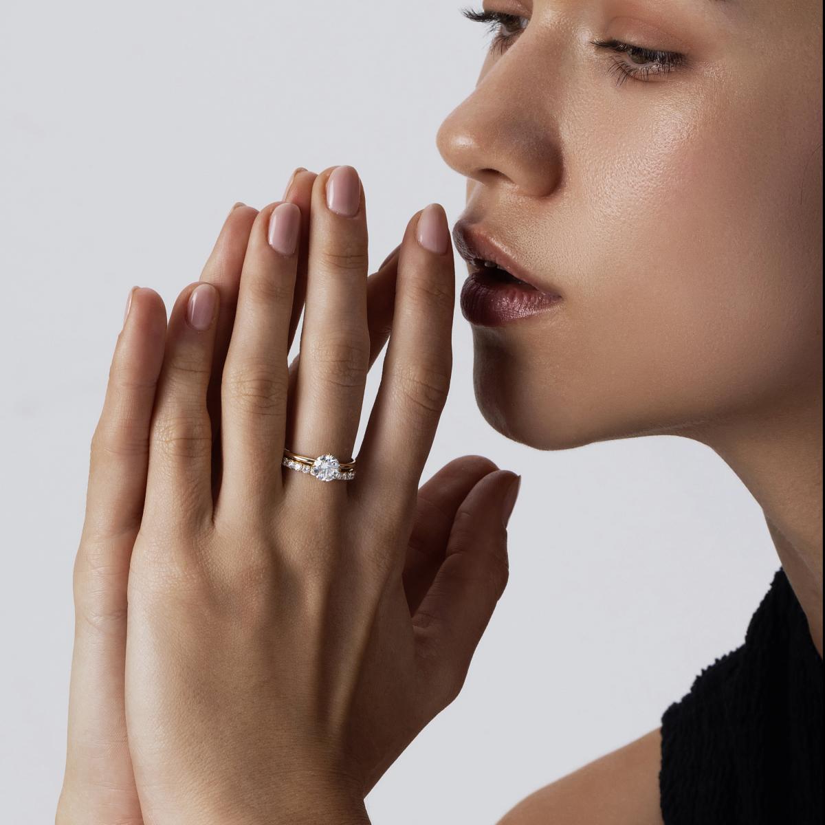 Model wearing Layla Round cut diamond ring stacked with a slim pavé band