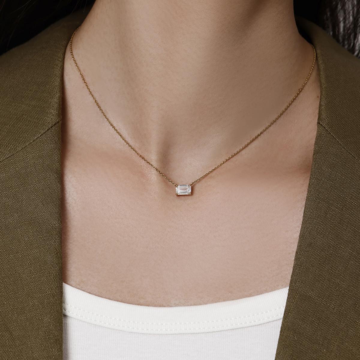 Model wearing a 1.0ct East West Emerald Cut Diamond Necklace 16–18" Chain Length (adjustable)