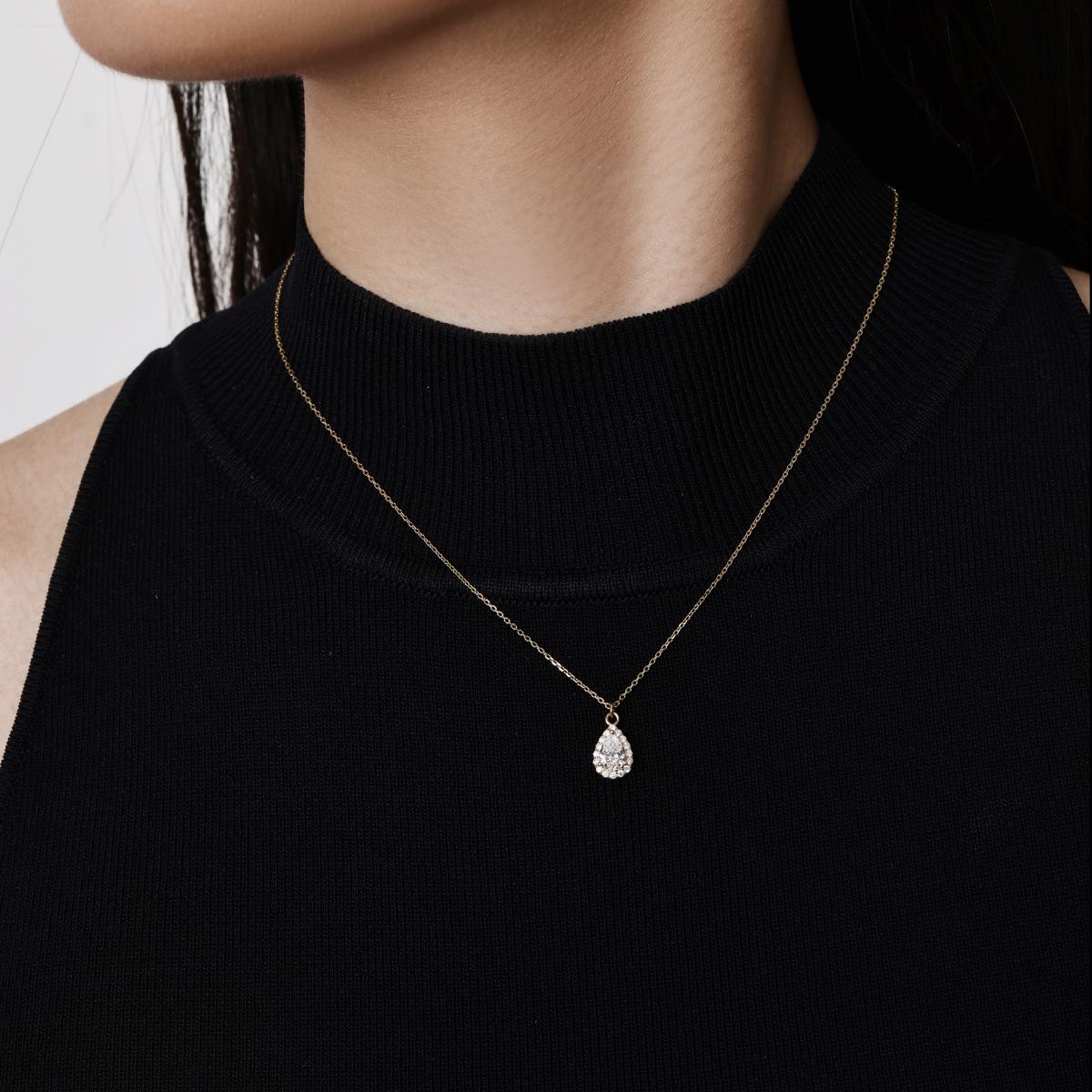 Model wearing a Halo Pear Cut Diamond Pendant Necklace 16–18" Chain Length (adjustable)