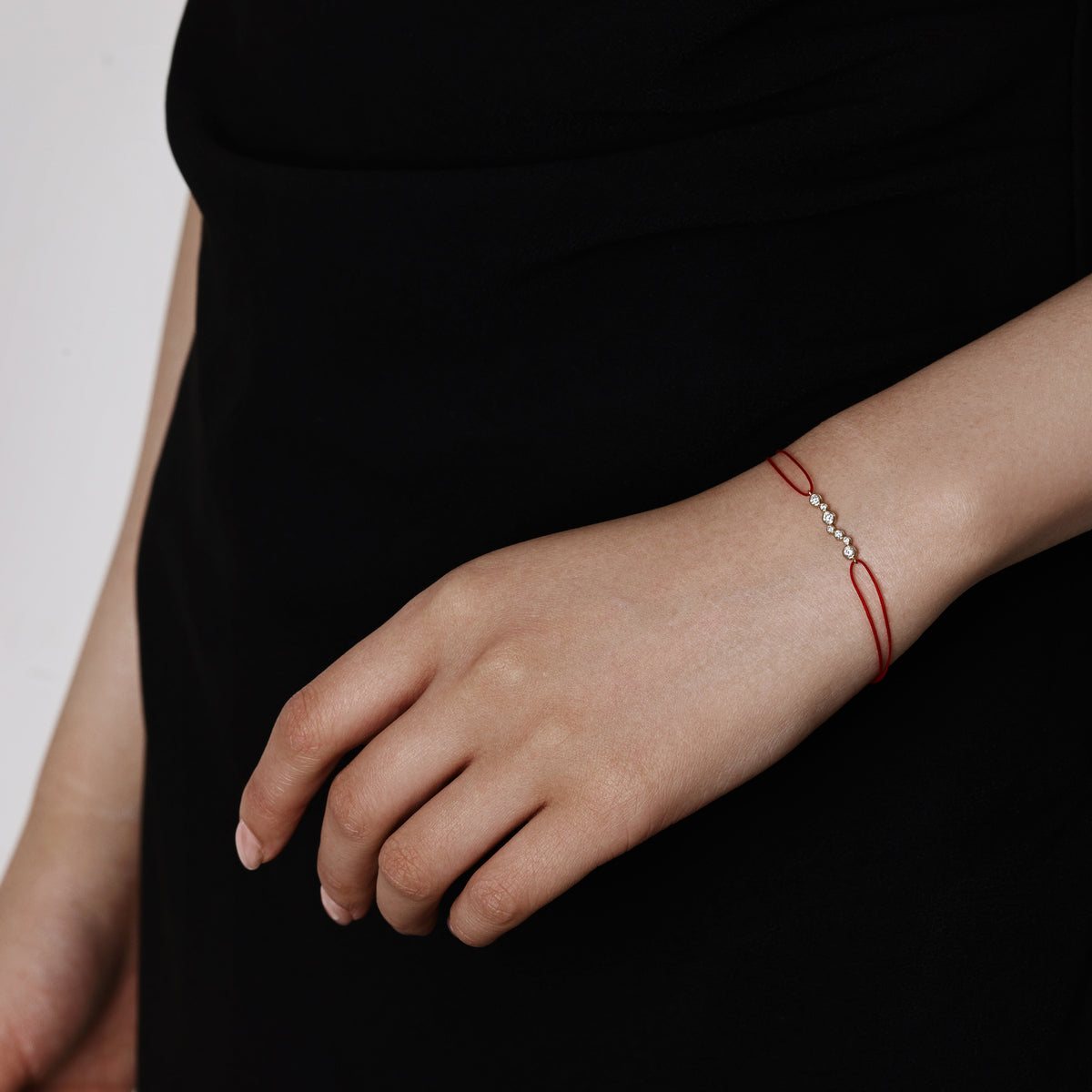 Model wearing a Mixed Bezel set Round Diamond Bracelet Red Cord 6.5” Bracelet Length (165mm)