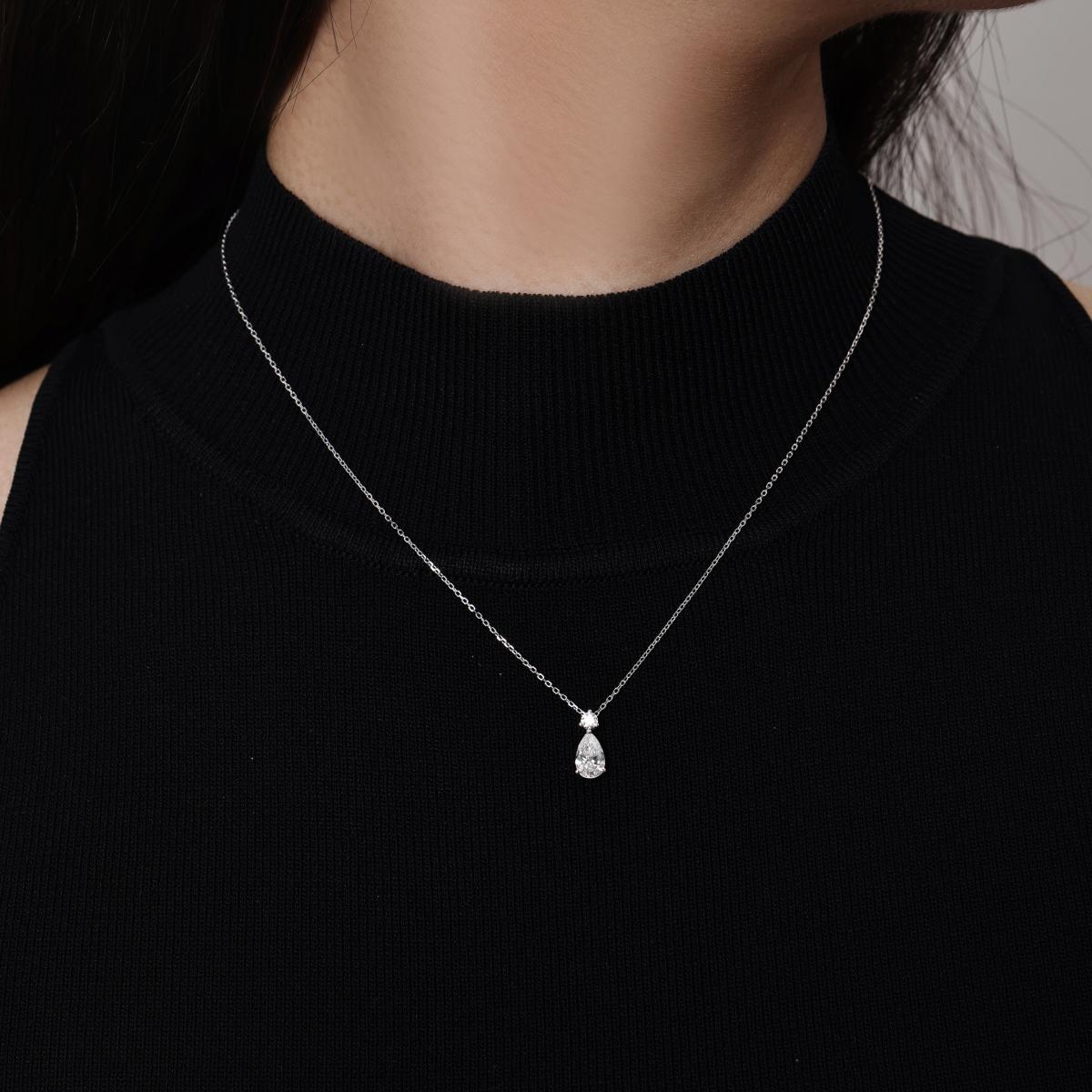Model wearing a Pear Cut Diamond Pendant Necklace in Platinum 16–18" Chain Length (adjustable)