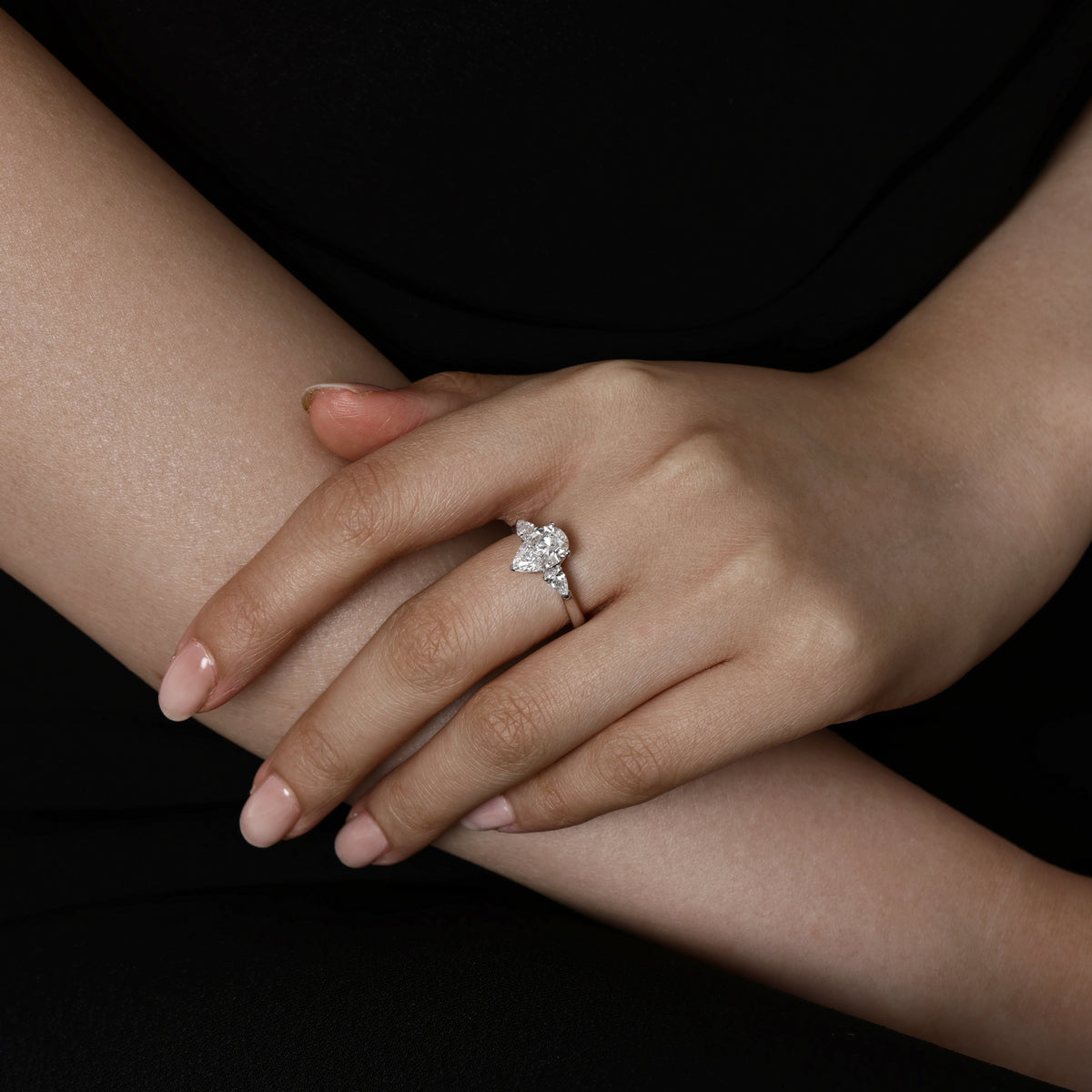 Model wearing a Three Stone Pear Shaped Lab Grown Diamond Engagement Ring in Platinum