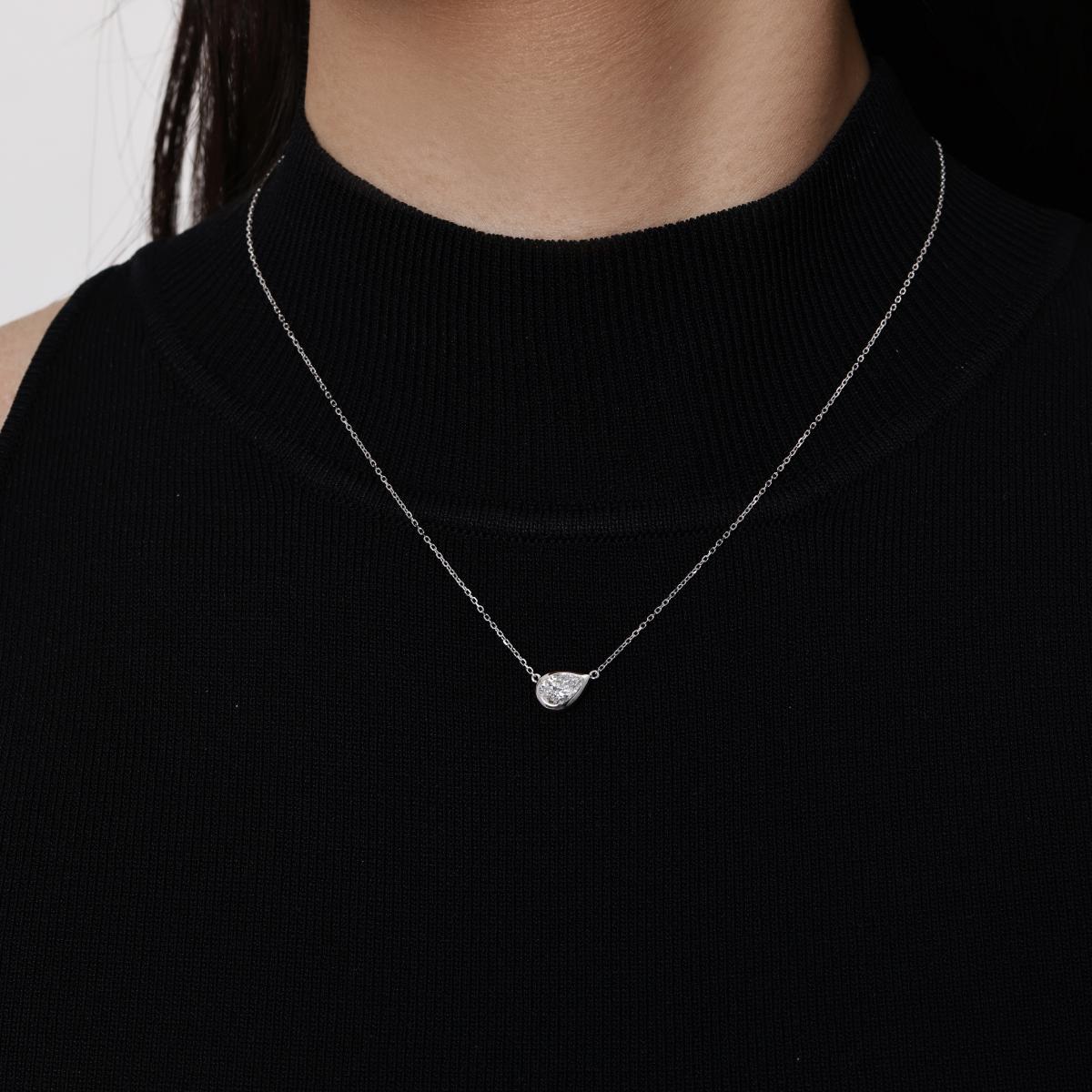 Model wearing a Tilted 0.76ct Pear Cut Diamond Necklace in Platinum Bezel 16–18" Chain Length (adjustable)