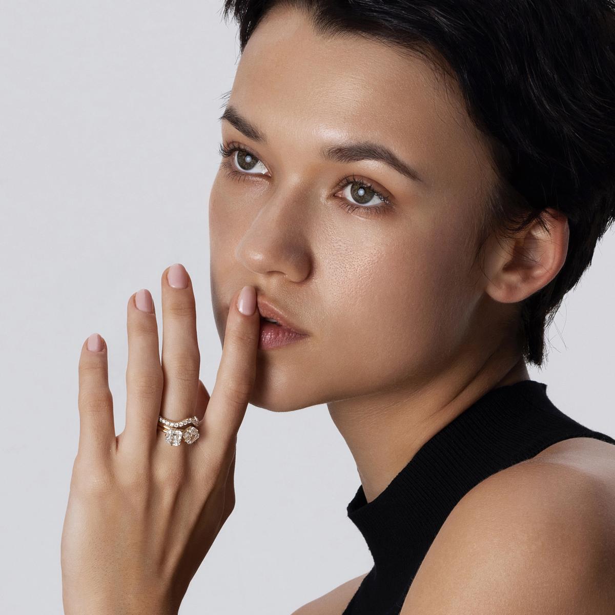 Model wearing a stacked ring look featuring two Asscher cut lab-grown diamond rings and a complementary band
