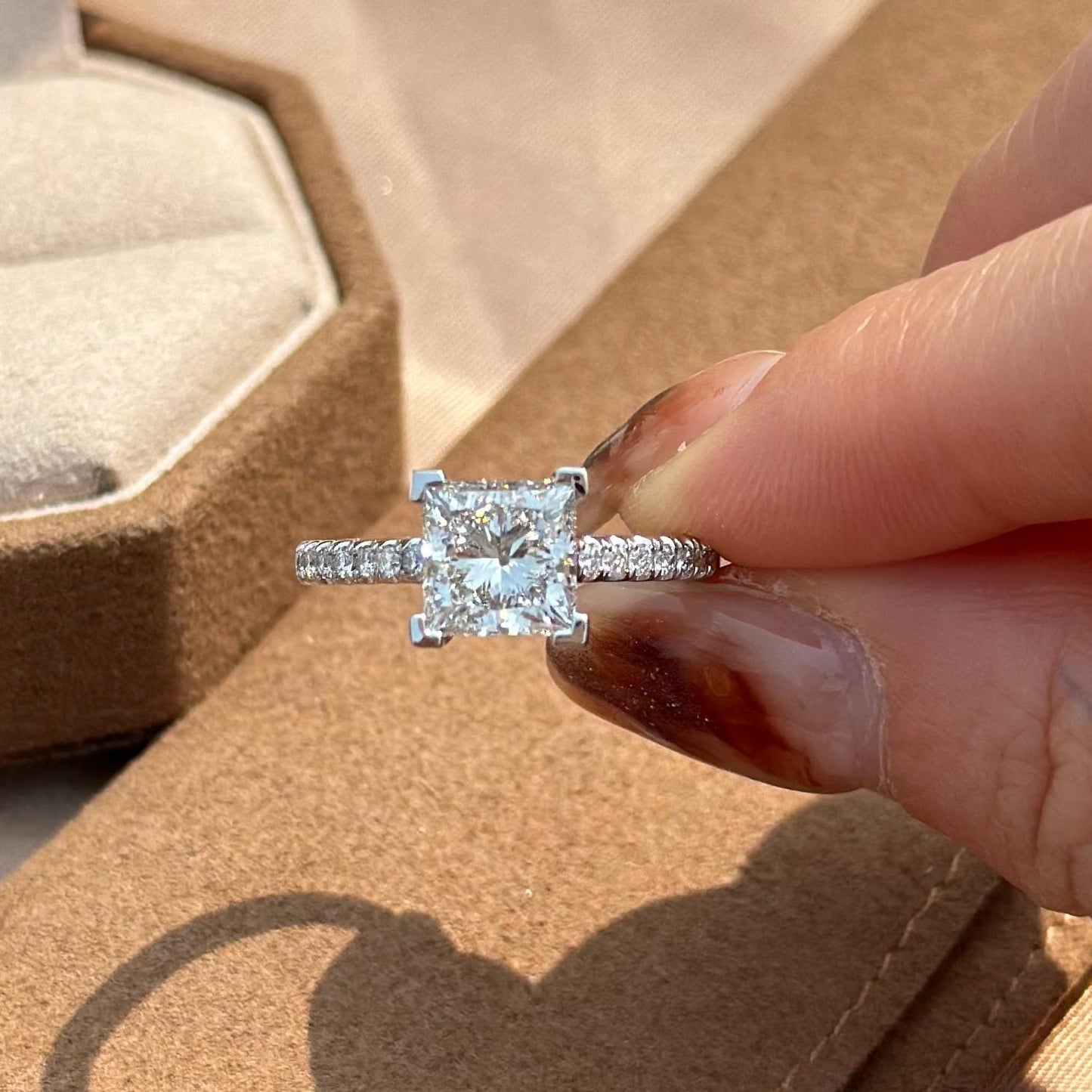 Overhead view of a pavé setting Princess cut diamond ring in PT950 platinum