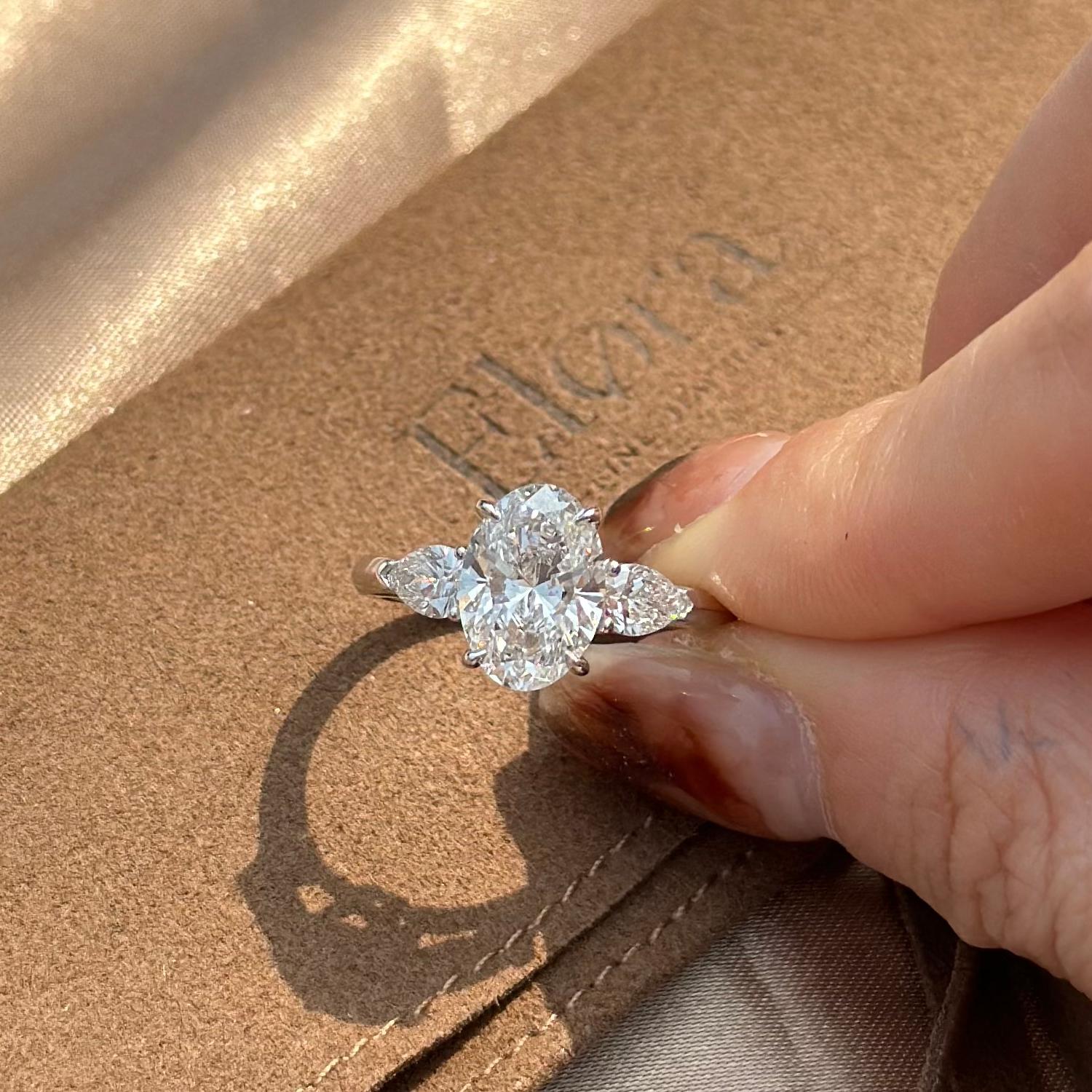 Overhead view of a three-stone Oval cut diamond with 2 pear diamonds