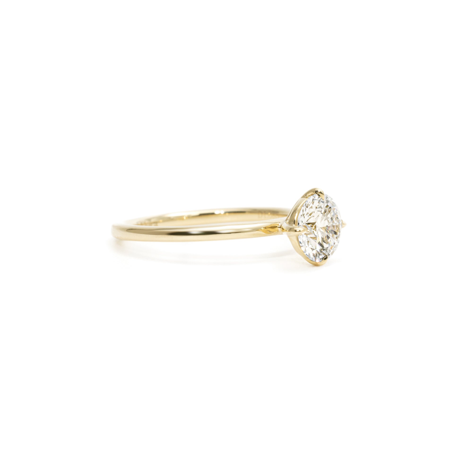 Side profile showing Round cut diamond with secure prong setting and tapered band