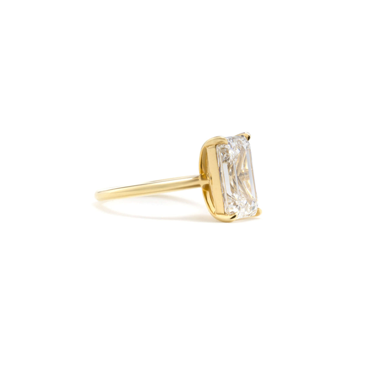 Side view of Jude solitaire ring in four-prong setting showing clean, minimal band design