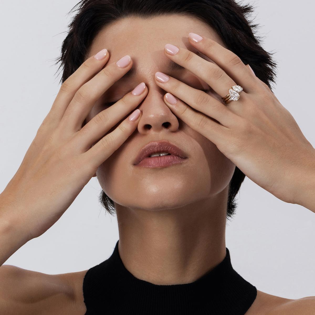 Stacked look featuring Violet tilted pear cut diamond ring paired with a pear-shaped solitaire