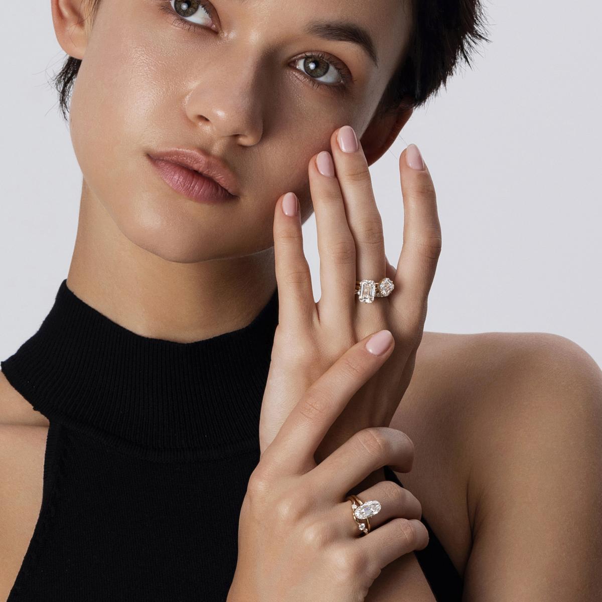 Stacked look featuring emerald cut diamond ring paired with a asscher-shaped solitaire