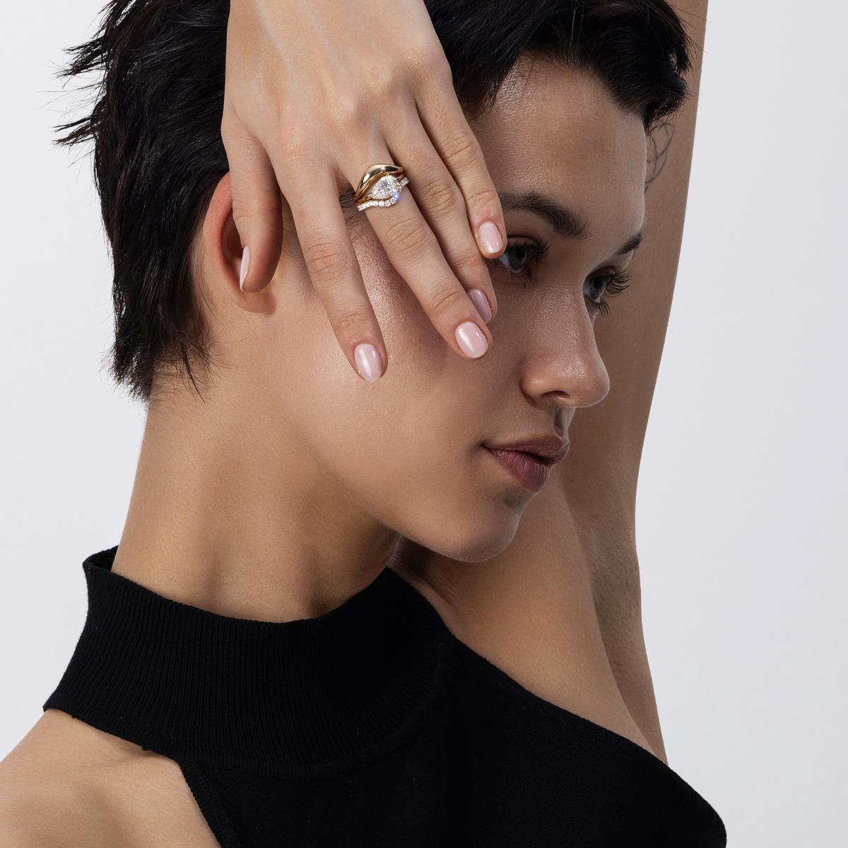 Stacked ring look featuring an East-West Pear diamond ring and 2 contour bands in yellow gold