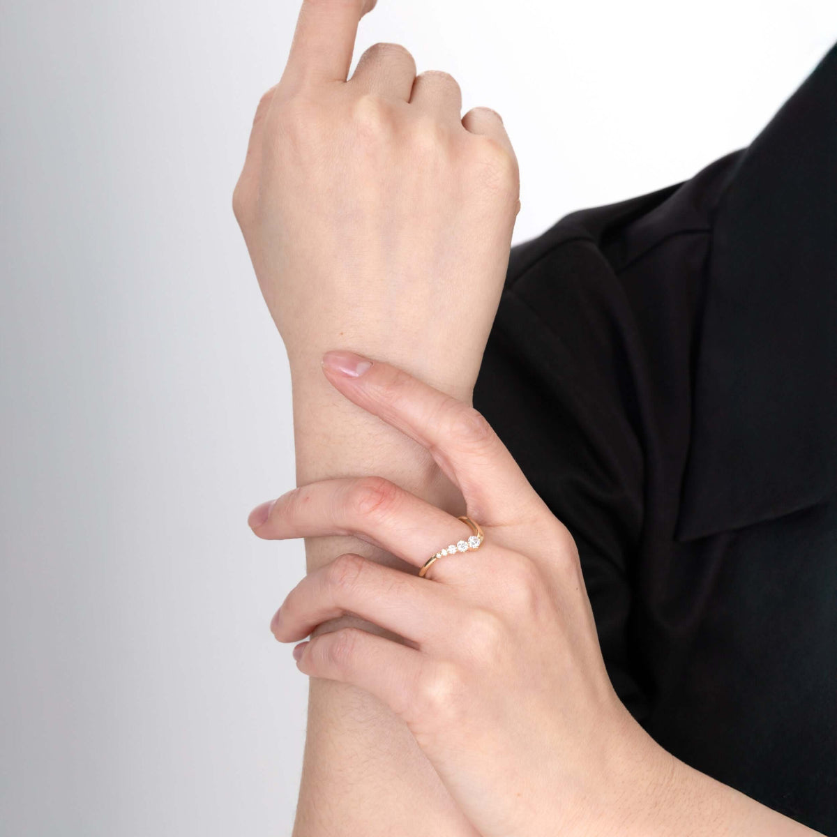 Top-down Clara wedding ring image on white background with light reflection