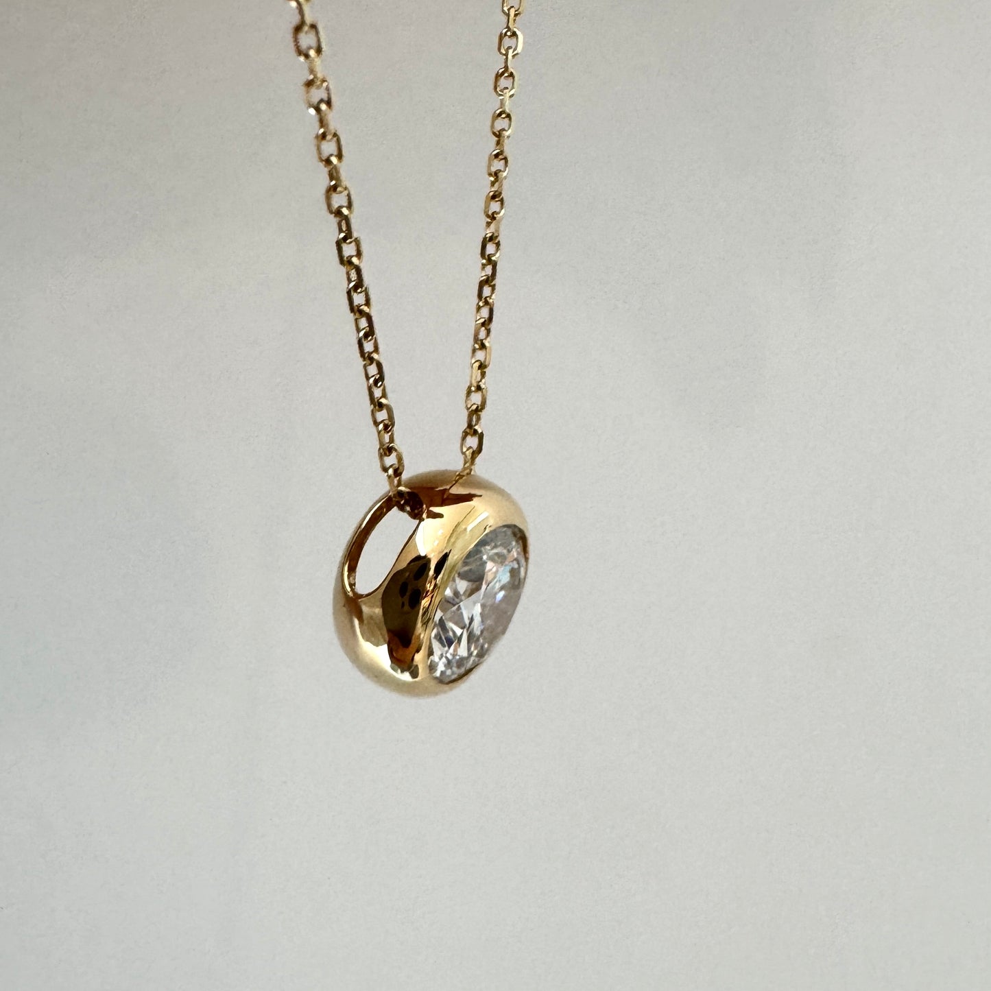 side_view_of_bezel_round_cut_diamond_Pendant_Necklace_Elora_Asher