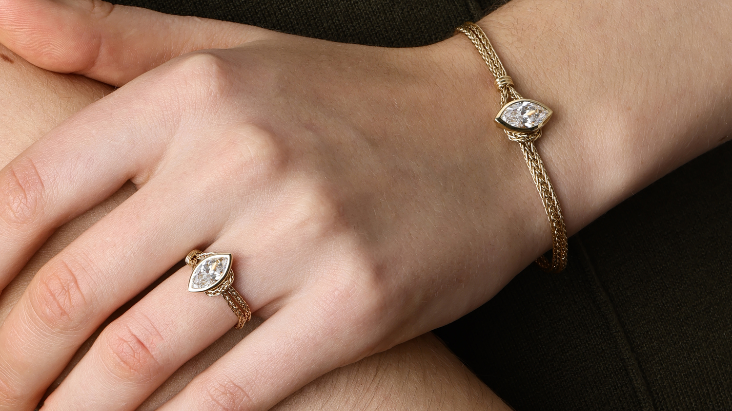 Elegant hand wearing a Chain Ring and matching bracelet featuring lab-grown diamonds on a gold chain.
