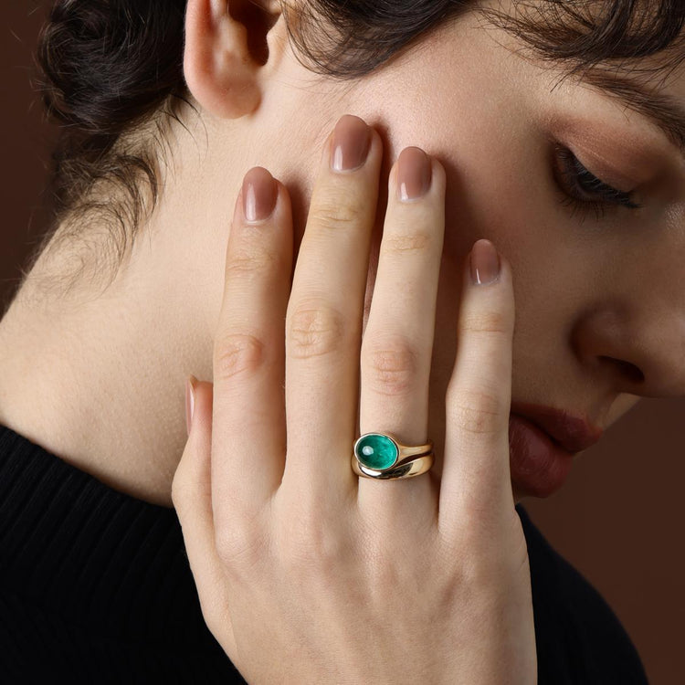 Model Wearing an Oval Cut Lab Grown Emerald Ring styled with matching Curved Wedding Band
