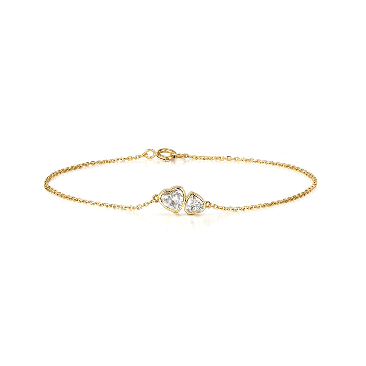 Gold gift bracelet featuring two heart-shaped stones for a charming accessory.