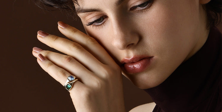 Close-up of a woman wearing a Gemstone Aquamarine ring, showcasing its clear blue hues and elegant design.