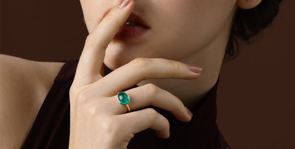 Model showcasing a beautiful Gemstone Emerald ring, emphasizing elegance and style.