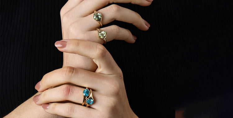 Gemstone Tourmaline rings featured on elegant hands showcasing vibrant colors and unique designs.