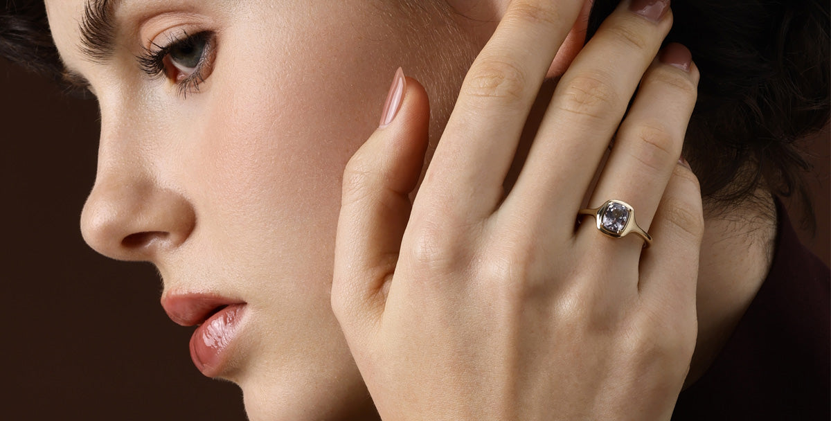 Grey Gemstone ring showcased on a model's hand, highlighting its sleek design and moody tones.