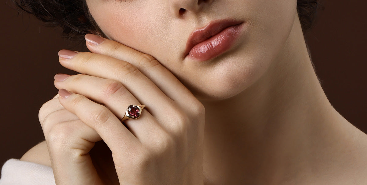 Red Gemstone ring showcased on model's hand, highlighting its fiery ruby and elegant design.