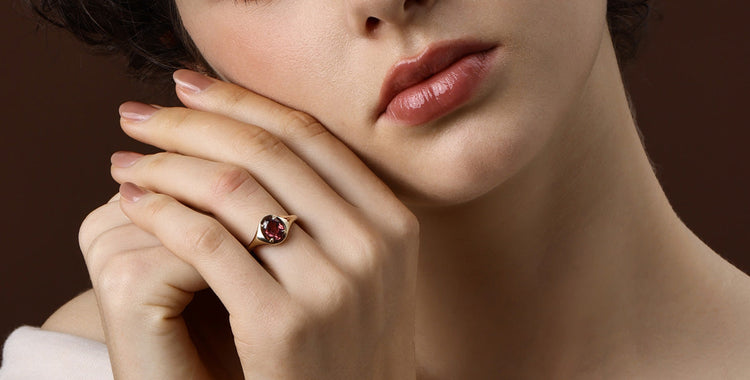 Red Gemstone ring showcased on model's hand, highlighting its fiery ruby and elegant design.