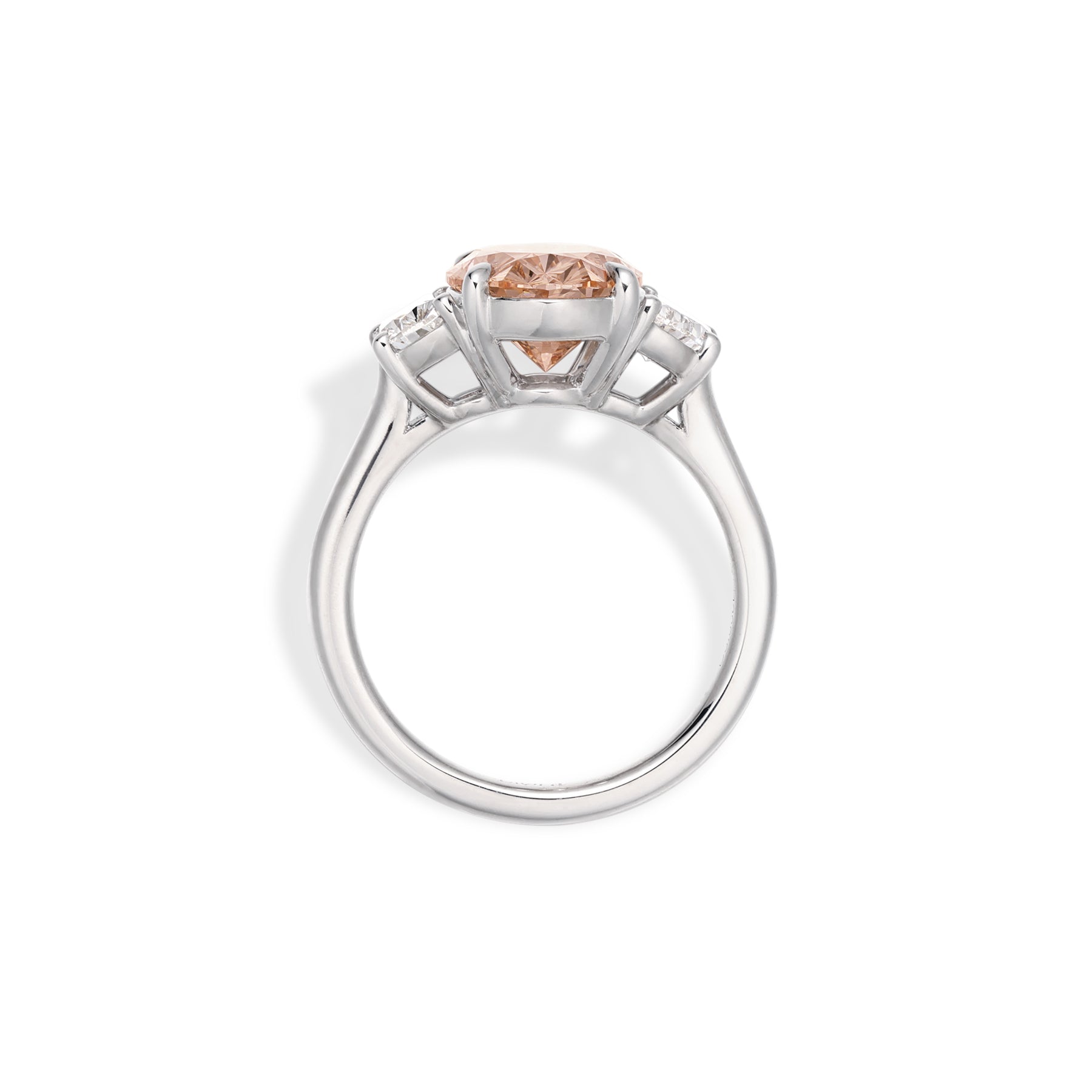 Side profile of pink oval cut lab grown diamond ring with half-moon diamond side stones
