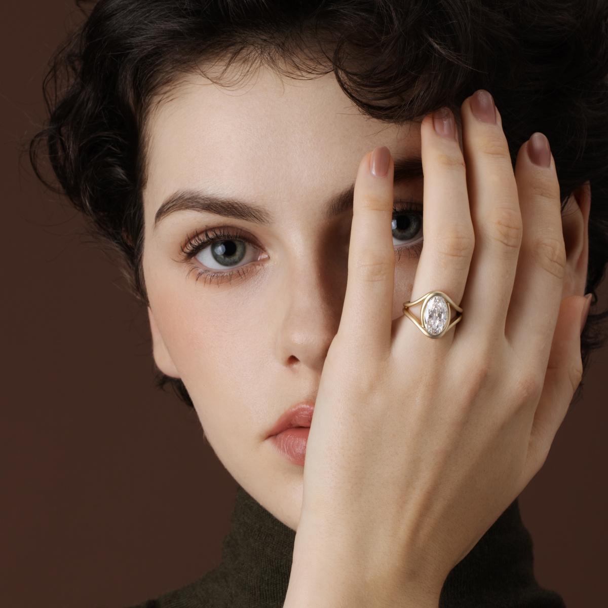 Model wearing a moval cut lab grown diamond engagement ring