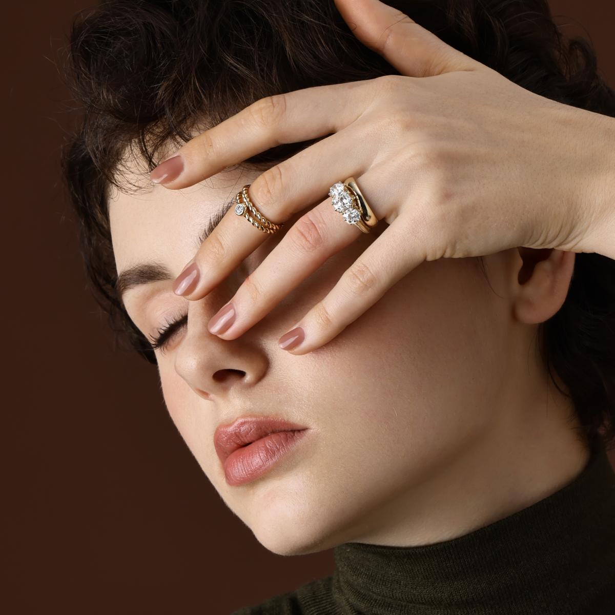Model wearing the Marcella Antique Cut Lab Grown Diamond Three Stone Engagement Ring with matching curved band
