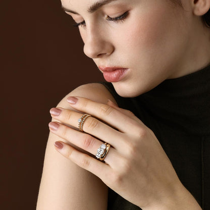 The Marcella Antique Cut Lab Grown Diamond Three Stone Engagement Ring with matching curved band shown on hand