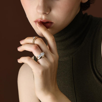 The Marcella Antique Cut Lab Grown Diamond Three Stone Engagement Ring with matching curved band worn on hand
